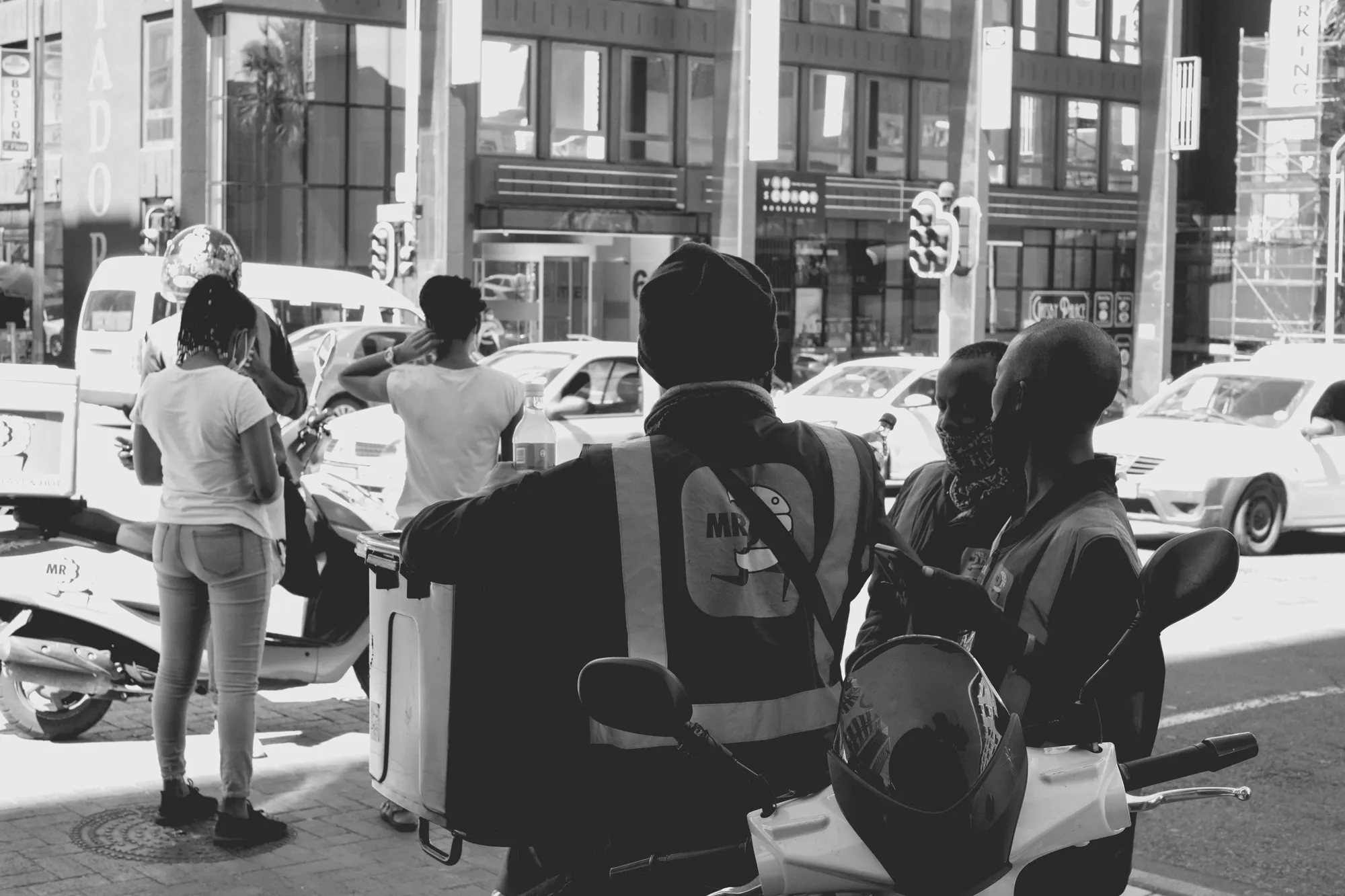 2022-02-16 - Cape Town - Delivery drivers standing next to motorbikes